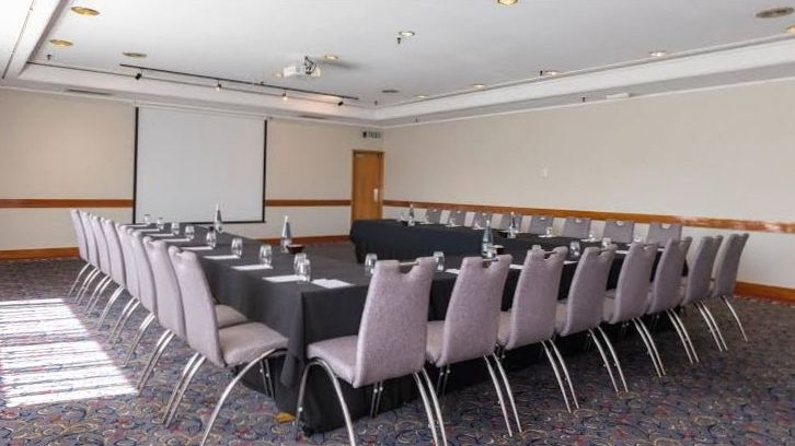 Private meeting room with timber table and lake view